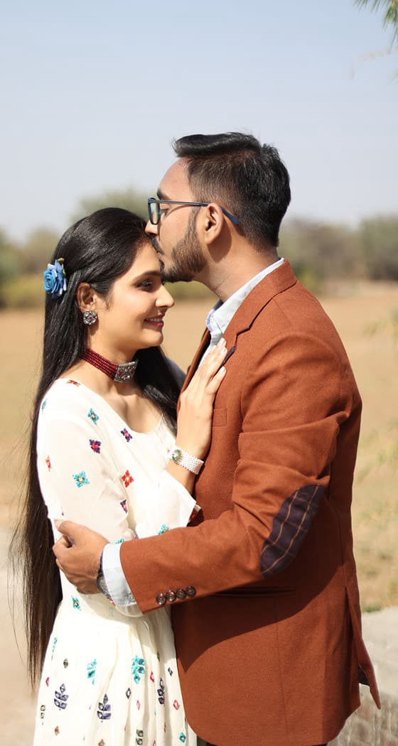 A Indian man is kissing his girl